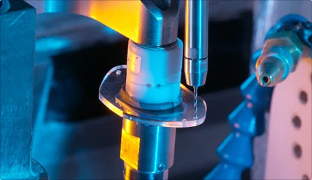 Lens edging machine cutting a custom lens in the Reimbold Eye Group onsite lab in Alpharetta